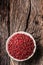 Red peppercorn in bowl on oak table