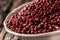 Red peppercorn in bowl on oak table