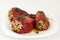 Red peppers stuffed with meat and rice. Filled peppers in white plate