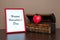 Red photo frame and opened decorative chest with heart on wooden table