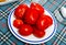 Red pickled tomatoes on plate close up. Preserve, fresh