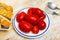 Red pickled tomatoes on plate closeup. Preserve, fresh