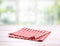 Red picnic gingham folded cloth on table