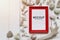 Red picture frame placed on a white wooden floor and with shells and white sea corals