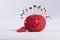 Red pin cushion with smily face on white background