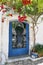 Red pink bougainvillea flower on greek door