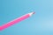 Red or pink color pencil floating front blue background