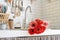 Red and pink gerbera daisies in a kitchen sink. Rustic kitchen interior design