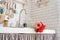 Red and pink gerbera daisies in a kitchen sink. Rustic kitchen interior design