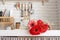 Red and pink gerbera daisies in a kitchen sink. Rustic kitchen interior design