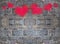 Red and pink heart paint on stone brick wall