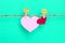 Red and pink heart shape hanging on rope with happy face icon for sweet romance and love valentines day concept