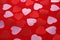 Red and pink hearts on red textiles. Valentine background