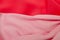 Red and pink silk fabric waves. Bright horizontal background