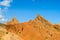 Red pinnacles of sandstone rocks at rainbow mountain canyon