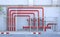 Red pipe of Fire Fighting systems in industrial zone in iron mesh fence. Water station in factory area zone