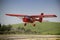 Red plane manned by student and teacher of a class flight practice, Jaen, Andalusia, Spain