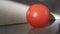 The red plastic ball on the floor where children played