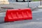Red plastic barrier blocking the road for the time of repair work on the replacement of asphalt.