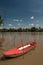 Red plastic boat floating on the river