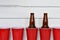 Red Plastic Drinking Cups and Two Beer Bottles