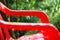 Red plastic garden chairs on the outdoor terrace in the home garden after the rain