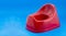 Red plastic potty for children - Text space