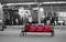 Red plastic seats on busy railway station platform