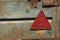 Red plastic triangular sign reflector on the trailer