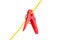 Red plastic washing line clothes pegs on a yellow cord isolated on white