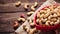 Red plate filled with peanut on top of a wooden table