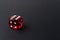 Red playing dice on black table. Luck and fortune concept