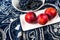 Red plumes and grapes on table