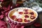 Red plums clafoutis flan, icing sugar dressing, french cuisine