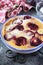 Red plums clafoutis, icing sugar dressing
