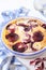 Red plums clafoutis, icing sugar dressing