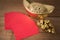 Red pocket and ancient Chinese golden ingots on wooden