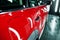 Red polished car in professional detailing garage