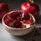 red pomegranate in the center of a white bowl