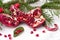 Red pomegranate, fir branches, lollipops,  on a white  background, Christmas