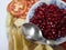 Red Pomegranate Plate  of India,Red pomegranate seeds in a bowl with a spoon.