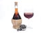 Red pomegranate wine in glass and straw wine bottle with shabbat metal decoration