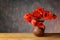 Red poppies in a ceramic vase