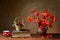 Red poppies in a ceramic vase, books,cherries and metal pots on the table