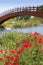 Red poppies flowers meadow river wooden bridge