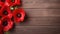 Red poppies on wooden background, top view. Space for text