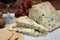 Red porto and cheese pairing, blue matured stilton English cheese served as dessert with walnuts and glass ruby porto wine