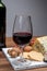 Red porto and cheese pairing, blue matured stilton English cheese served as dessert with walnuts and glass ruby porto wine