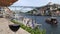 Red, Porto wine glass overlooking tourists at Cais da Ribeira, Porto, Portugal