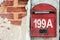 A red post box on a decaying brick wall in the heritage town of George Town